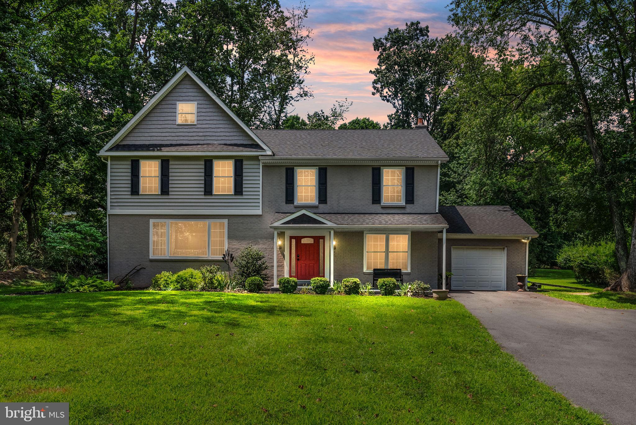 a front view of a house with a garden and yard