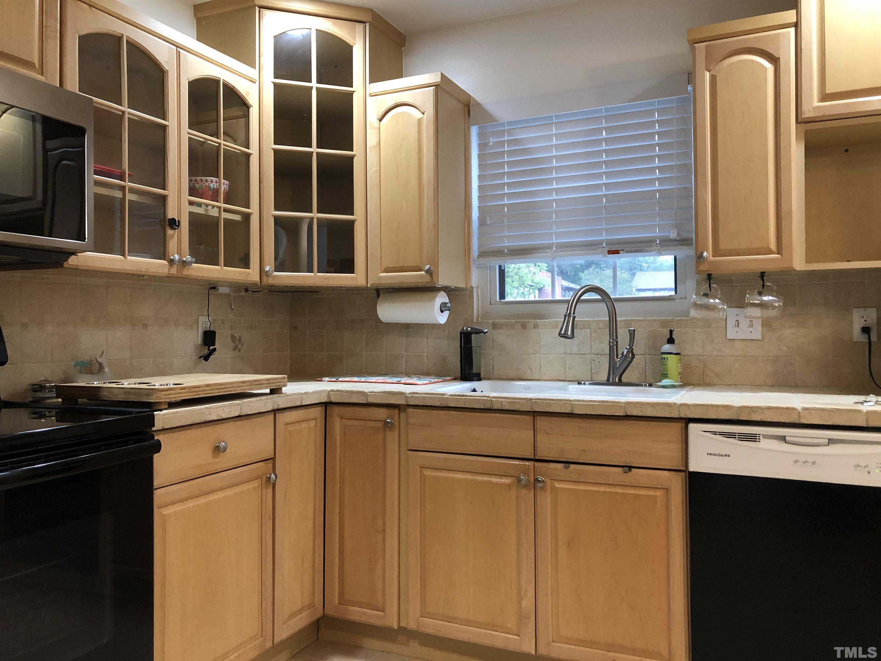 5805 Nottoway Court, Unit B Raleigh, NC 27609 - Photo 9 of 19 a kitchen with stainless steel appliances granite countertop a sink and cabinets