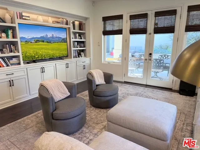 a living room with furniture window and flat screen tv