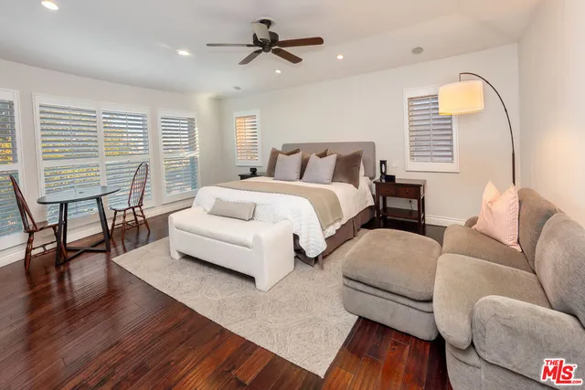 a spacious bedroom with bed and a large window