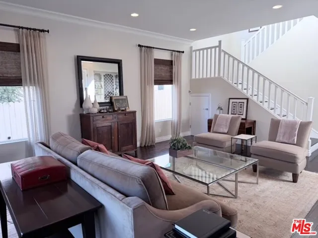 a living room with furniture fireplace and a window