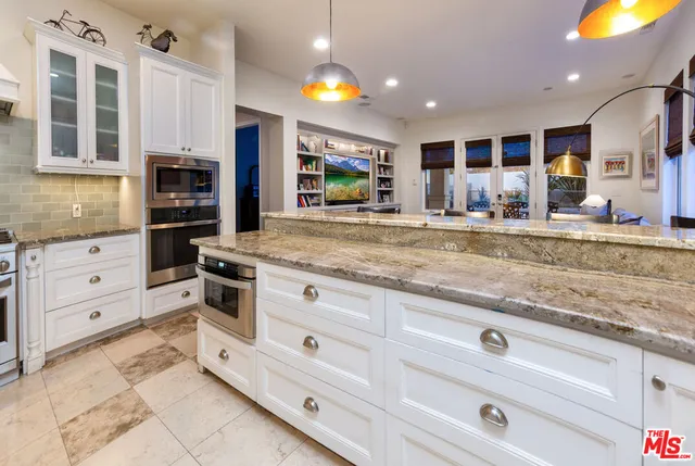 a kitchen with cabinets and window
