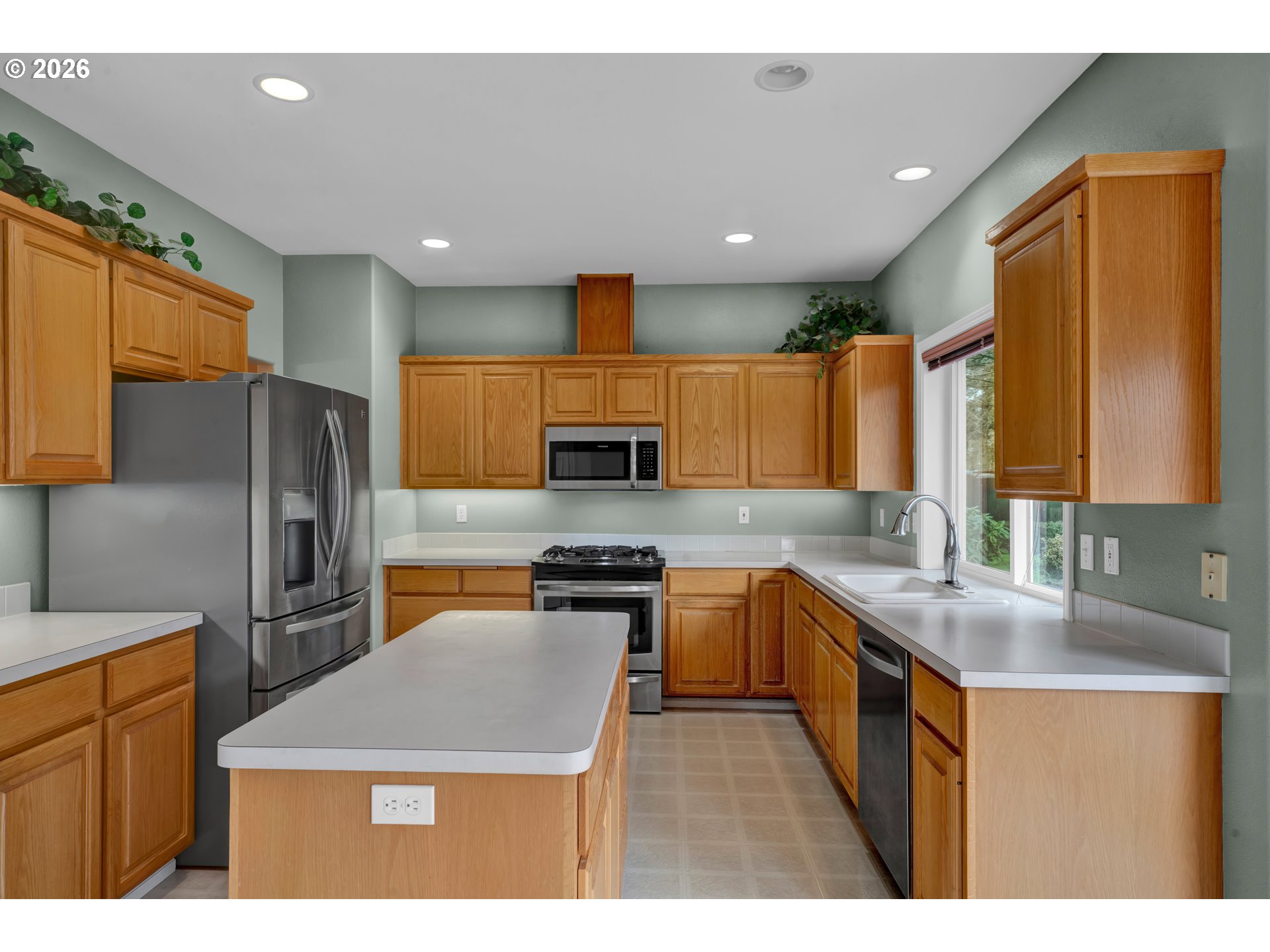 223 Beringer Court Eugene, OR 97404 - Photo 15 of 48 a kitchen with stainless steel appliances granite countertop a sink stove refrigerator and cabinets