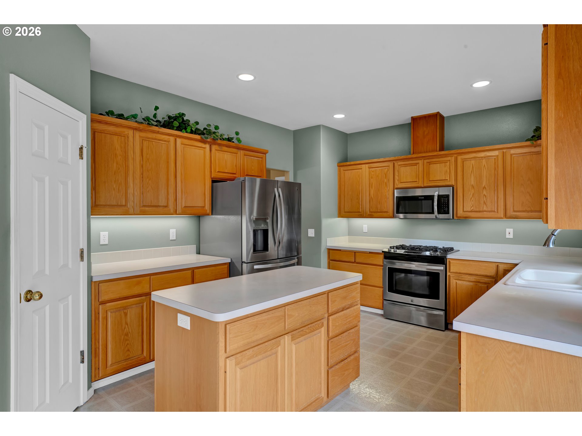 223 Beringer Court Eugene, OR 97404 - Photo 16 of 48 a kitchen with stainless steel appliances granite countertop a sink stove and refrigerator