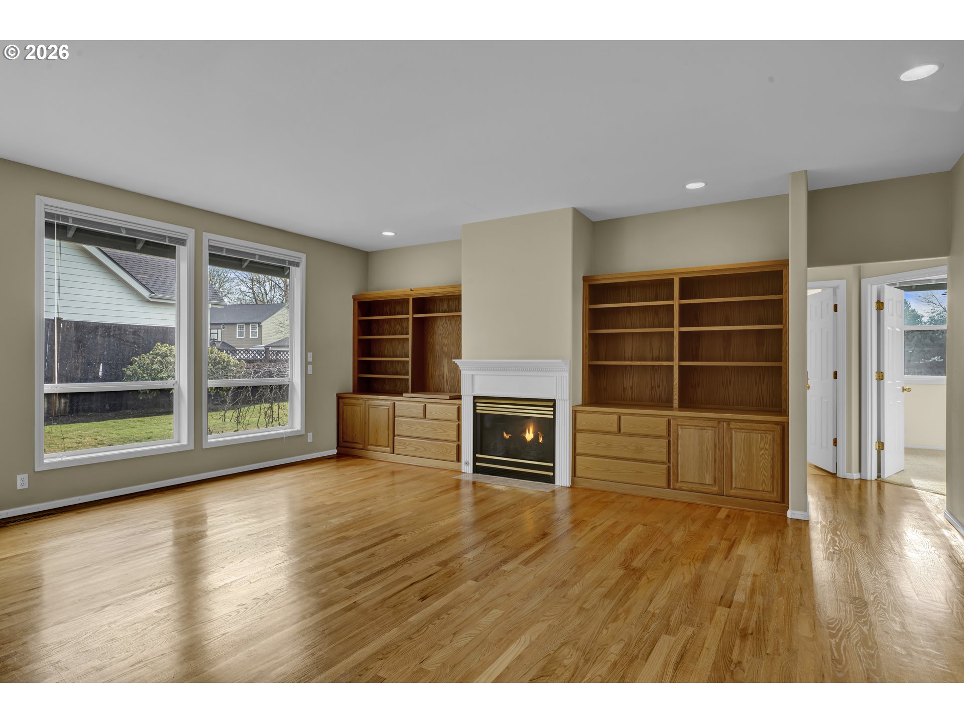 223 Beringer Court Eugene, OR 97404 - Photo 10 of 48 a view of an empty room with a fireplace and wooden floor