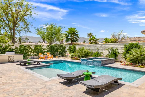 a view of swimming pool with outdoor seating