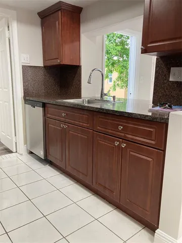 a kitchen with stainless steel appliances granite countertop a sink and a cabinets