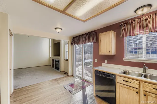 a kitchen with stainless steel appliances granite countertop a refrigerator oven a sink dishwasher and white cabinets with wooden floor