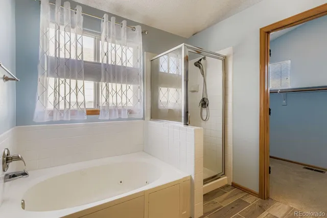 a bathroom with a bathtub and a shower