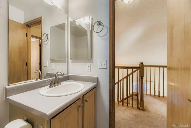 a bathroom with a sink vanity and a mirror
