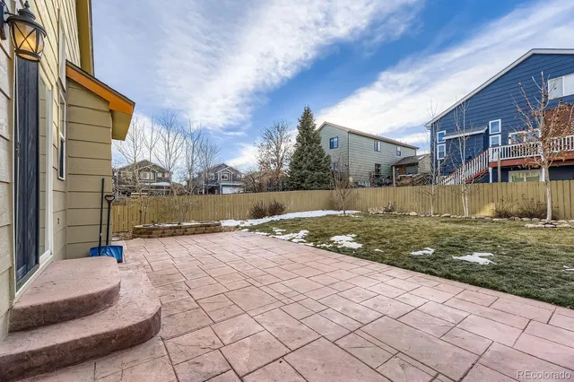 a view of a street with brick house in the background