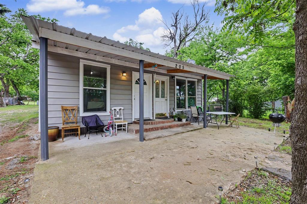 205 South Main Street Bonham, TX 75418 - Photo 1 of 23 a view of a house with backyard porch and sitting area