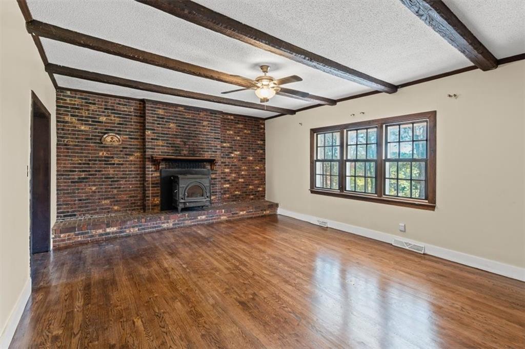 110 A Williams Road Southeast Silver Creek, GA 30173 - Photo 13 of 61 a view of an empty room with wooden floor fireplace and a window