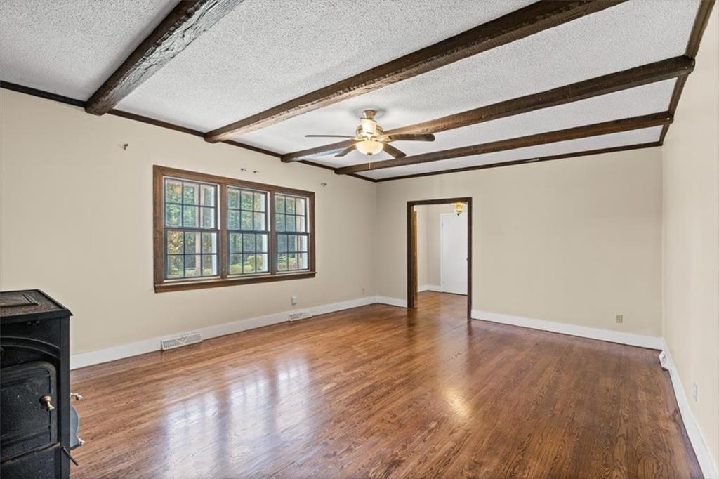 110 A Williams Road Southeast Silver Creek, GA 30173 - Photo 15 of 61 a view of an empty room with wooden floor and a window