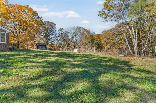 an aerial view of residential house with green space