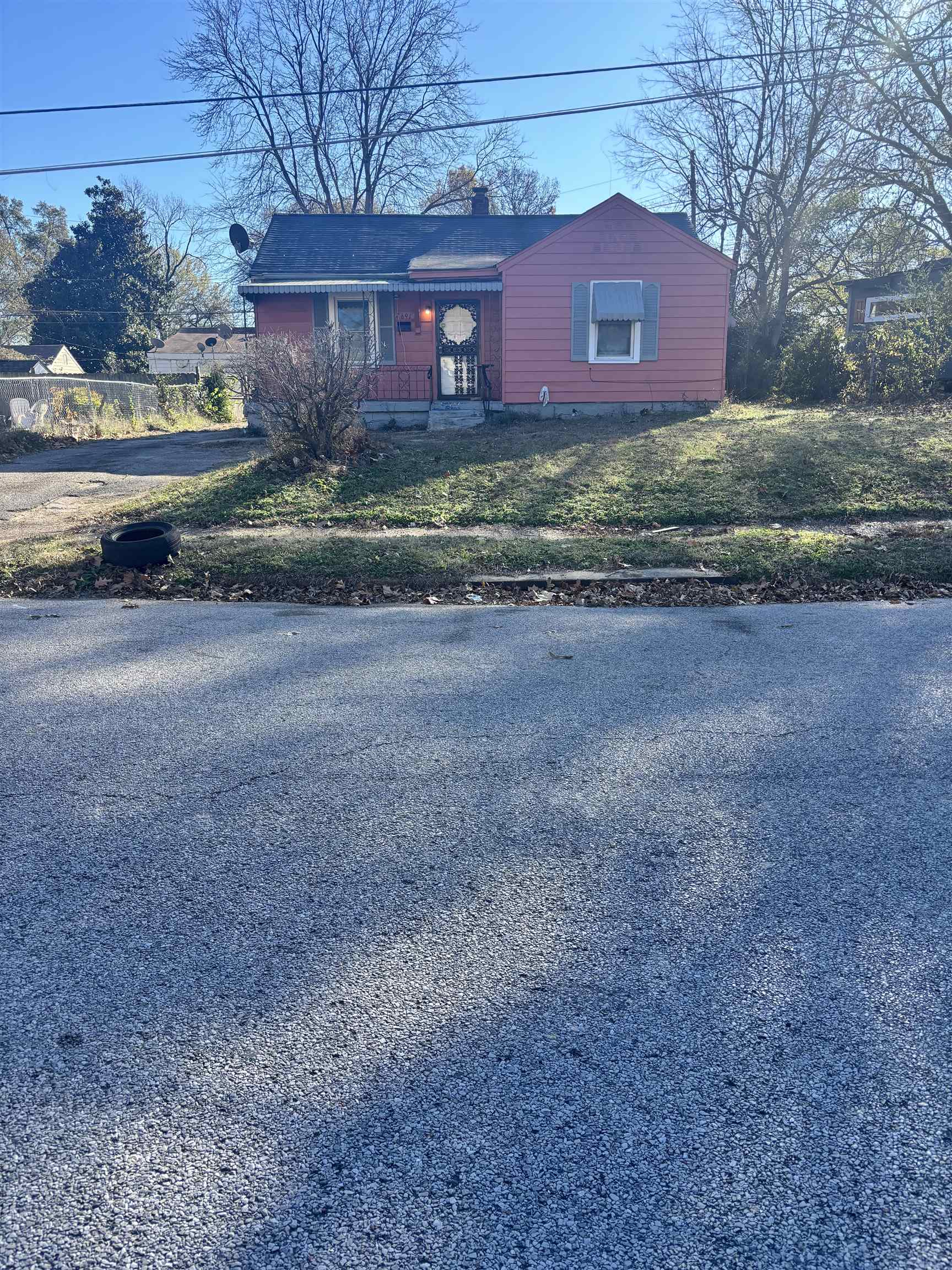 View of front facade featuring a front lawn and a chimney