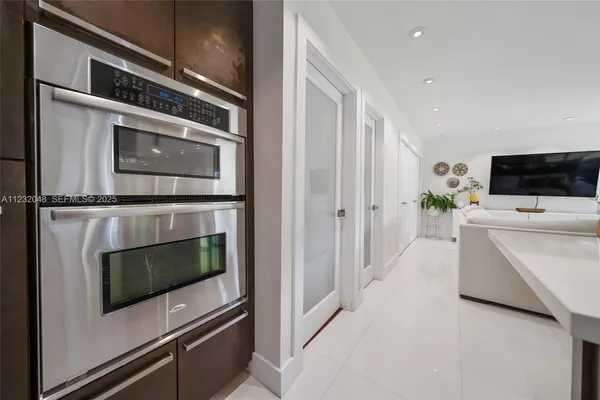 a kitchen with stainless steel appliances granite countertop a sink a stove and a refrigerator