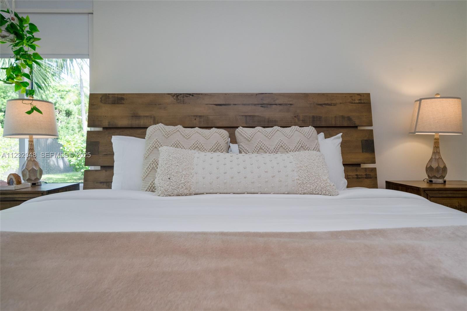 7544 Southwest 78th Terrace Miami, FL 33143 - Photo 24 of 60 a bedroom with a bed and a potted plant