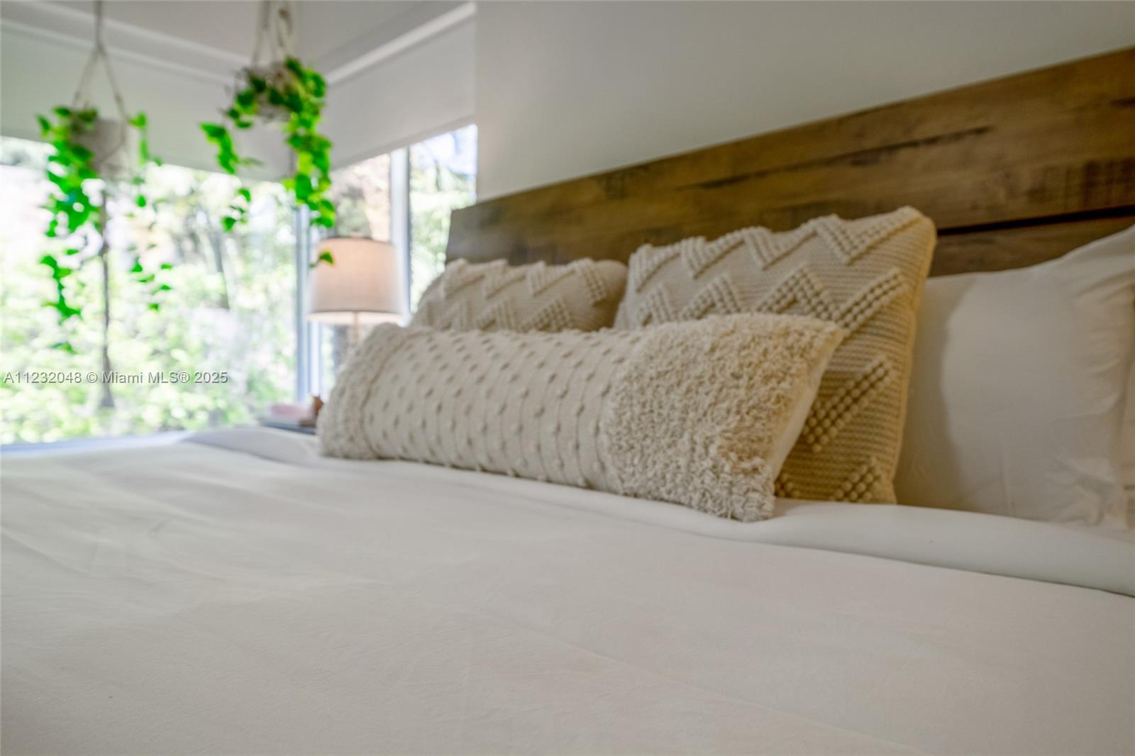 7544 Southwest 78th Terrace Miami, FL 33143 - Photo 27 of 60 a bed sitting in a bedroom next to a window