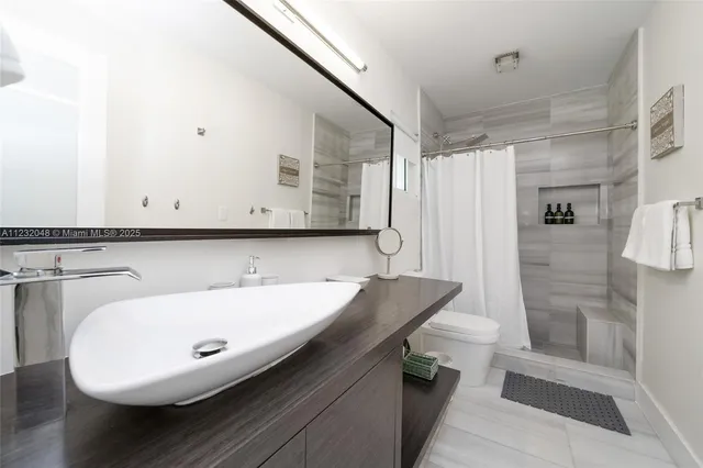 a bedroom with a rug and a lamp