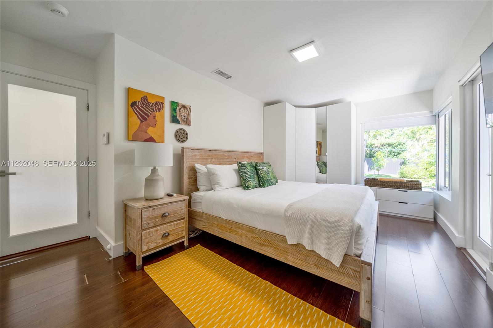 7544 Southwest 78th Terrace Miami, FL 33143 - Photo 34 of 60 a bedroom with a bed and a large window