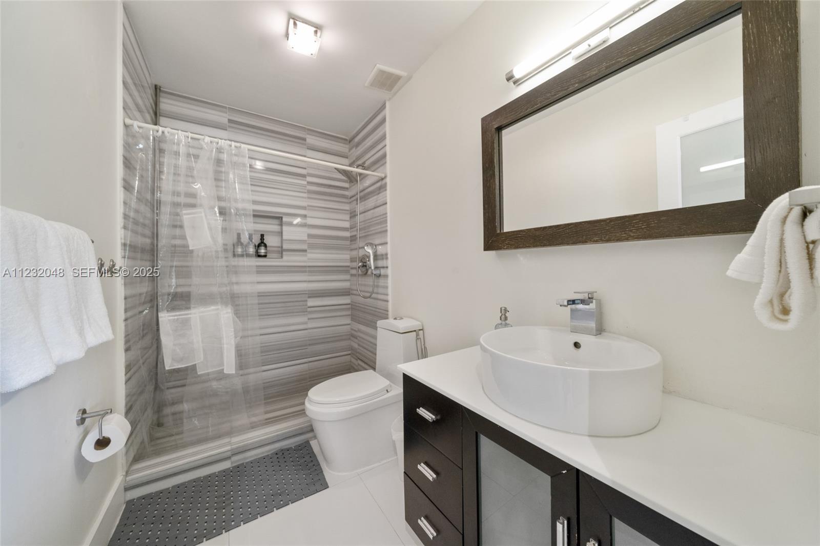 7544 Southwest 78th Terrace Miami, FL 33143 - Photo 39 of 60 a bathroom with a sink a toilet and shower