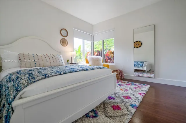 a view of a dining room with furniture and a potted plant