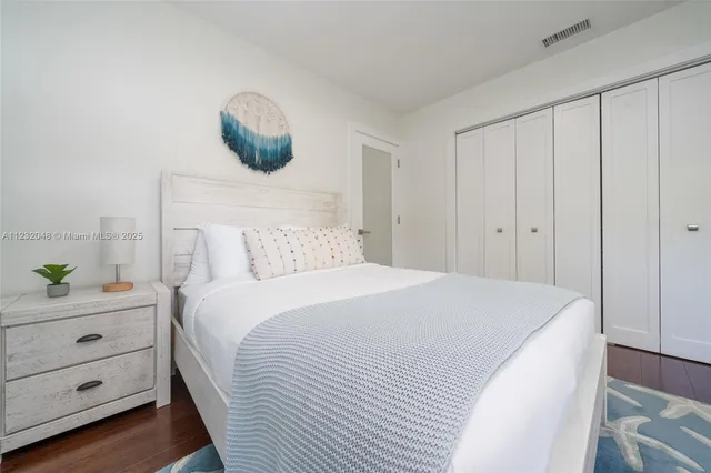 a bedroom with furniture and a flat screen tv