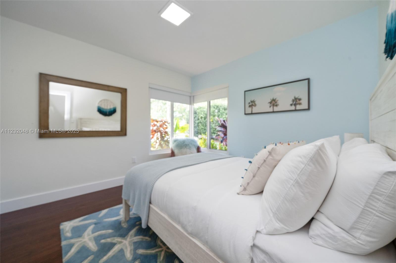 7544 Southwest 78th Terrace Miami, FL 33143 - Photo 46 of 60 a bedroom with a bed and a painting on the wall