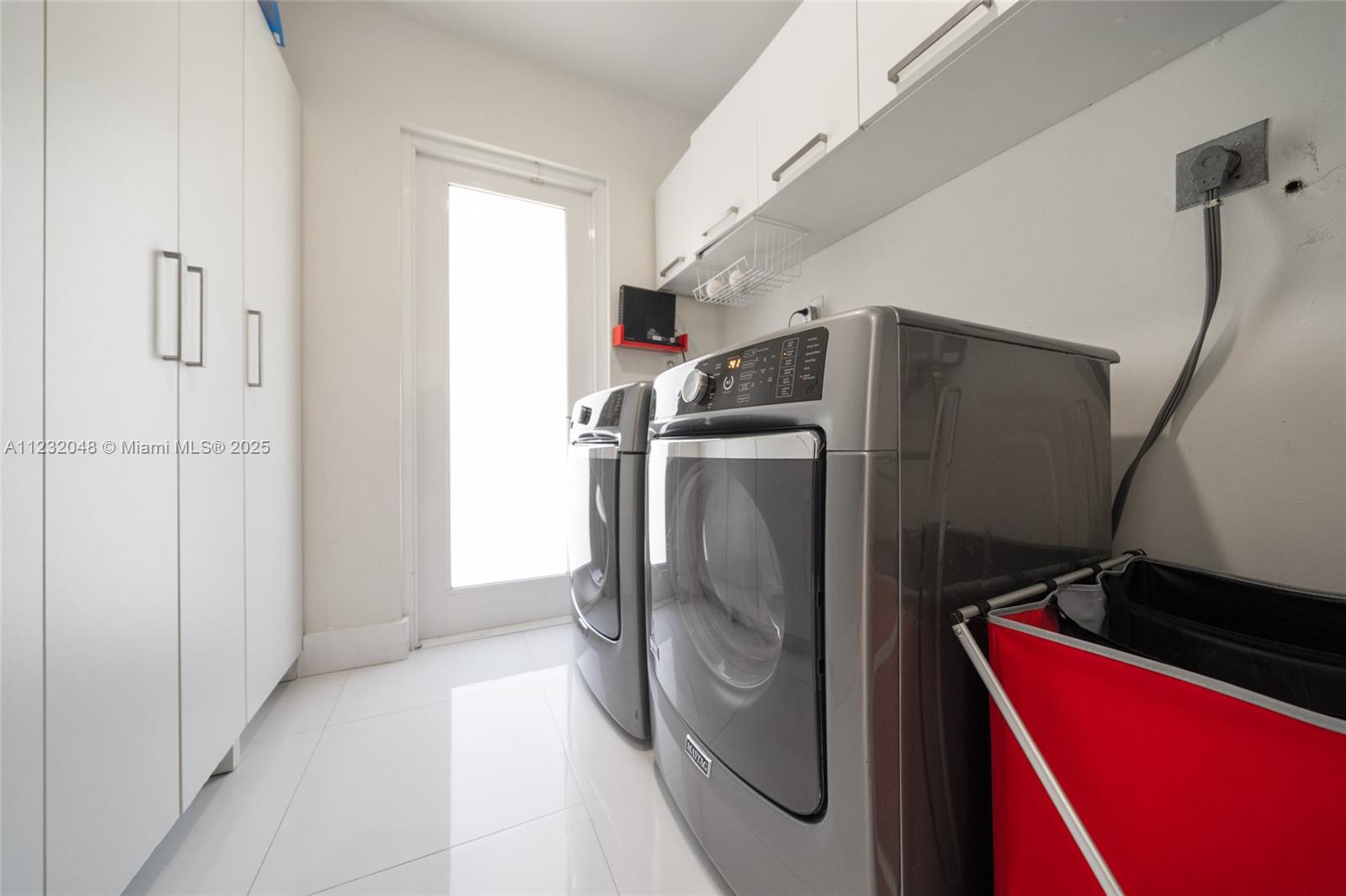 7544 Southwest 78th Terrace Miami, FL 33143 - Photo 49 of 60 a view of a storage and utility room with washer and dryer