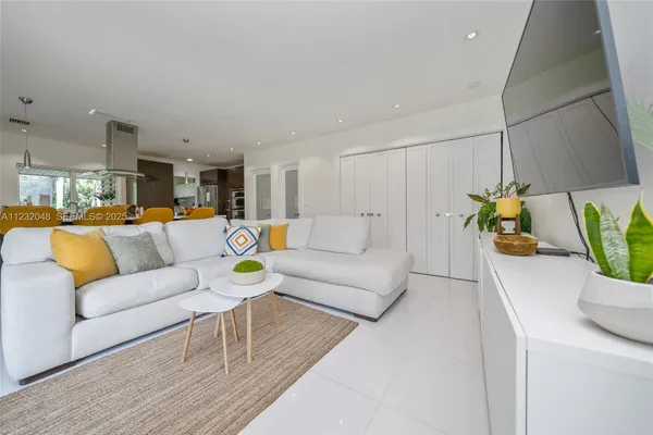 a dining room filled with furniture and a potted plant