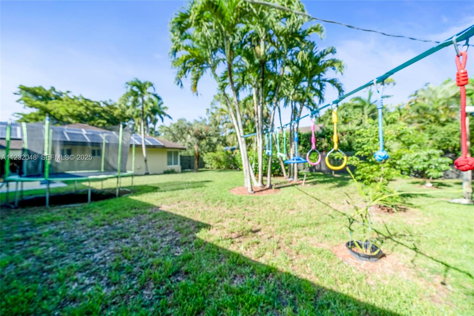 7544 Southwest 78th Terrace Miami, FL 33143 - Photo 56 of 60 a view of a backyard with plants and palm trees