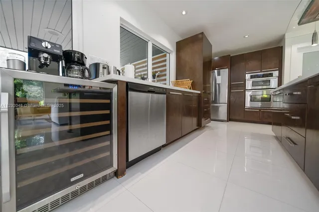 a kitchen with counter top space a sink appliances and cabinets