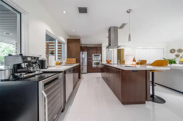 a view of living room with furniture and kitchen view