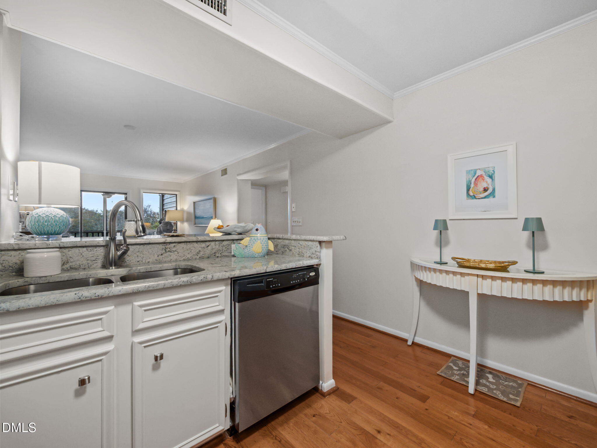 2308 West Fort Macon Road, Unit 204H Atlantic Beach, NC 28512 - Photo 11 of 83 a kitchen with stainless steel appliances granite countertop a sink cabinets and wooden floor