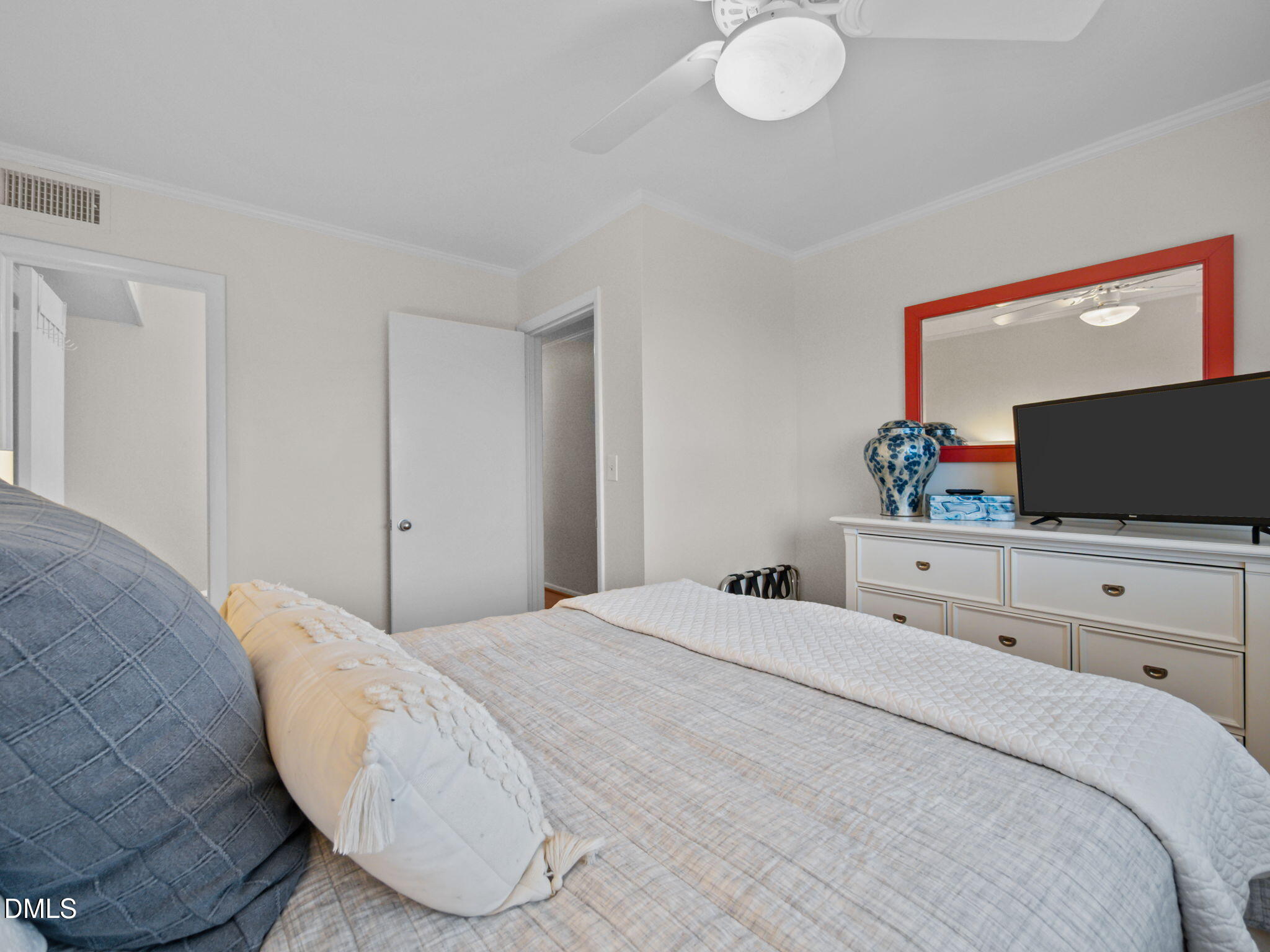 2308 West Fort Macon Road, Unit 204H Atlantic Beach, NC 28512 - Photo 38 of 83 a bedroom with a bed and a flat screen tv