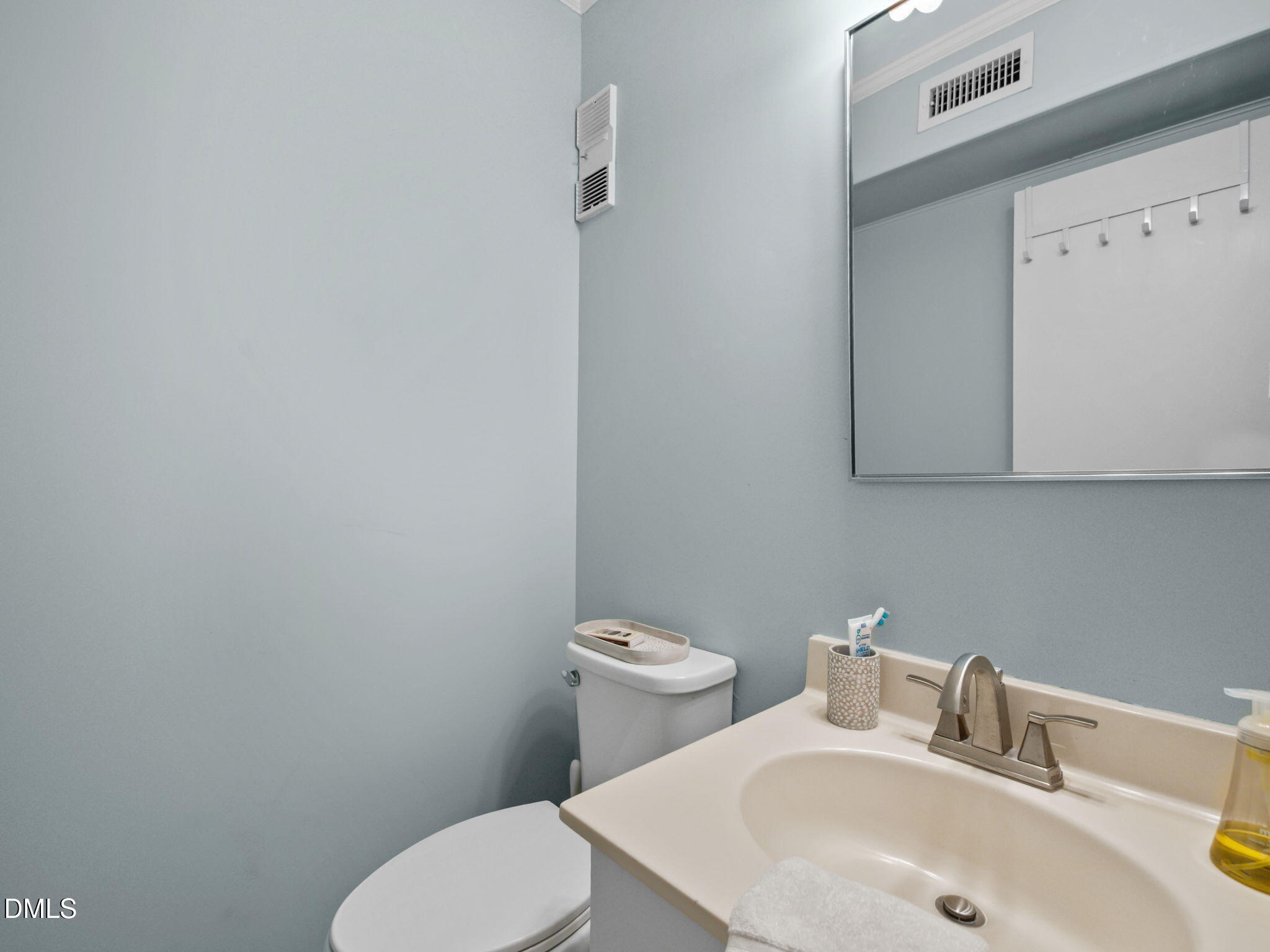 2308 West Fort Macon Road, Unit 204H Atlantic Beach, NC 28512 - Photo 39 of 83 a bathroom with a toilet sink and mirror