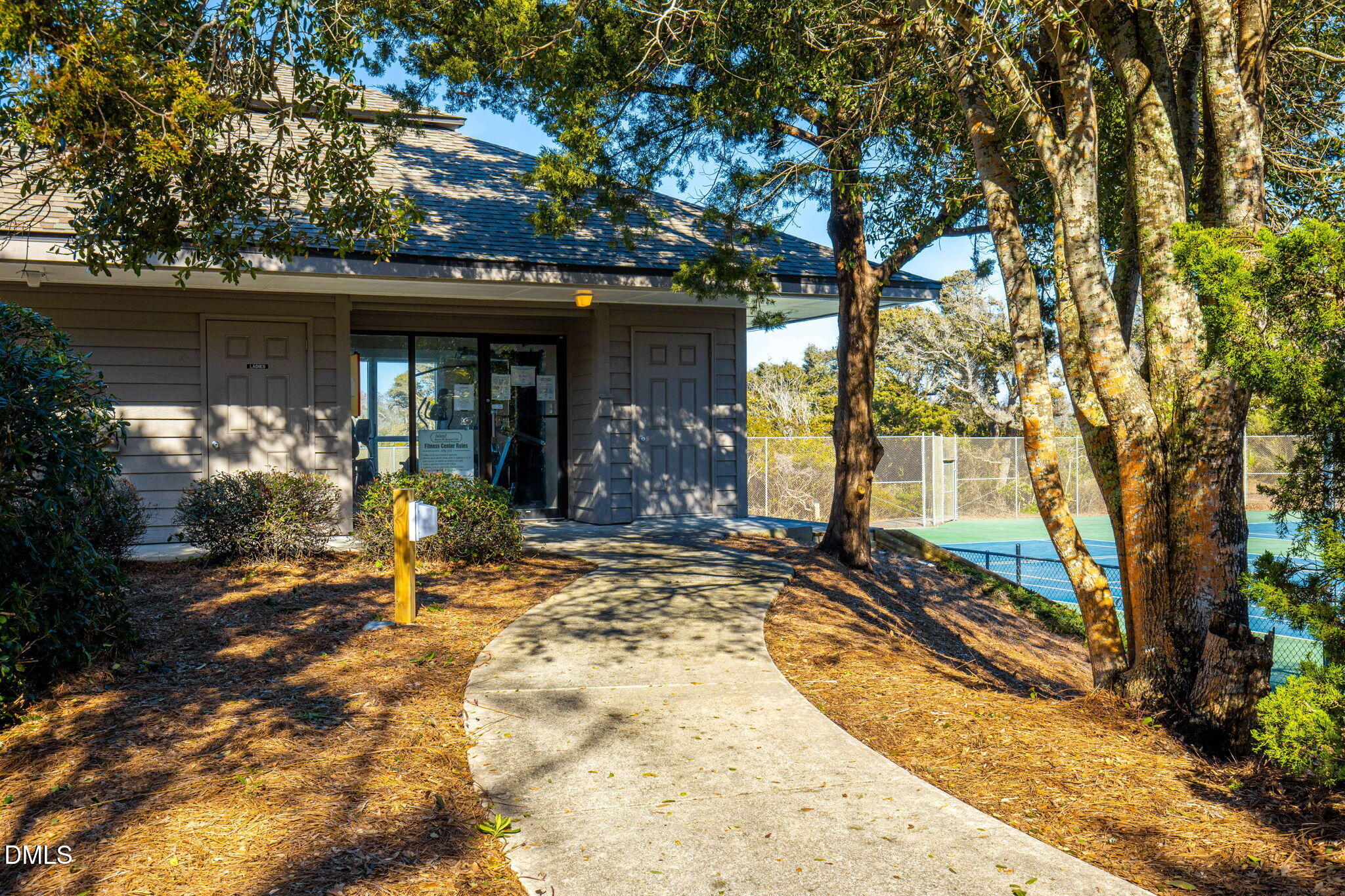 2308 West Fort Macon Road, Unit 204H Atlantic Beach, NC 28512 - Photo 52 of 83 a view of a house with backyard outdoor space and a tree