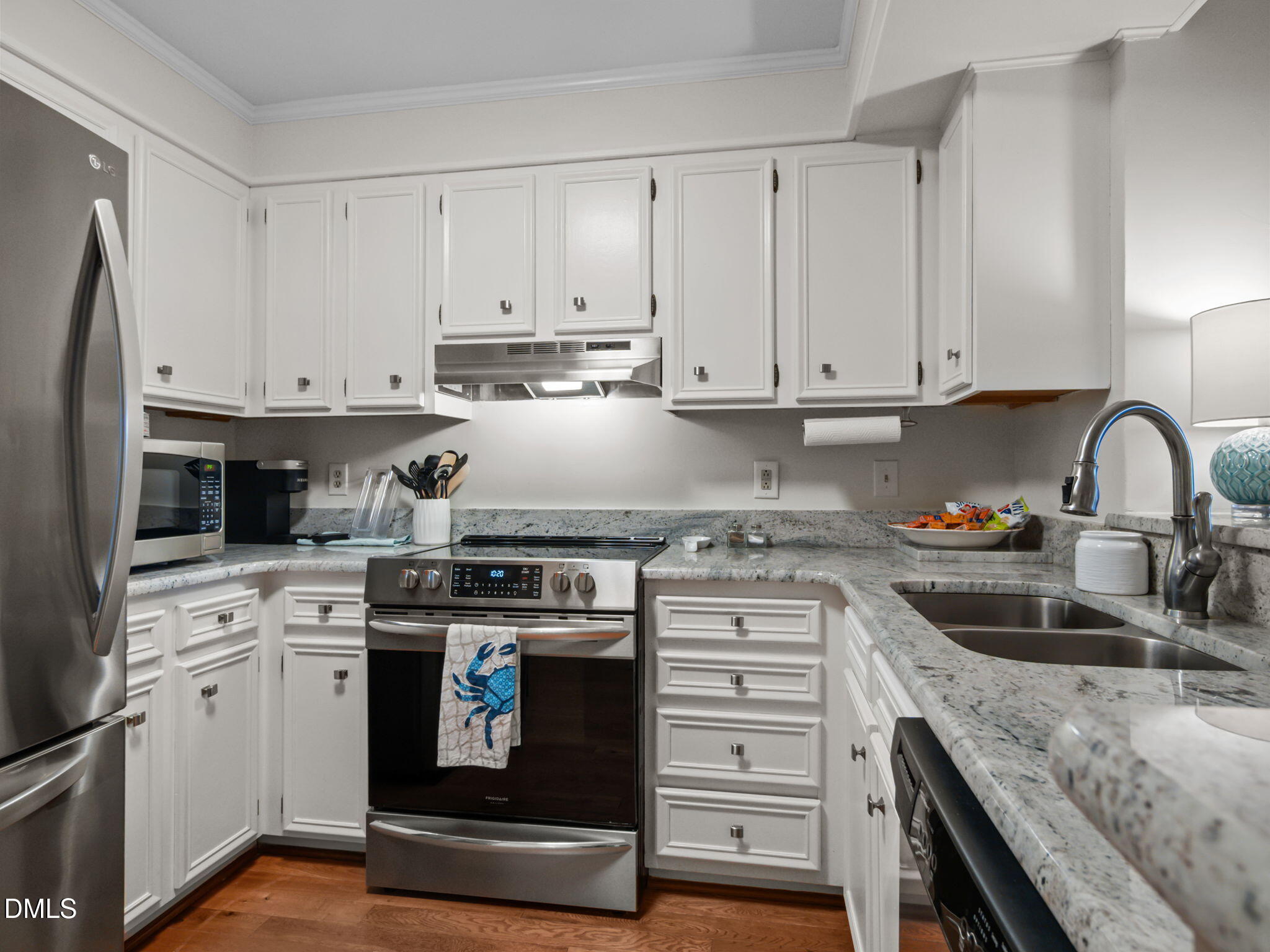 2308 West Fort Macon Road, Unit 204H Atlantic Beach, NC 28512 - Photo 9 of 83 a kitchen with granite countertop white cabinets and white appliances
