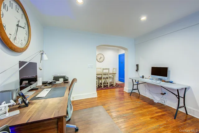 a view of a workspace with furniture and a flat screen tv