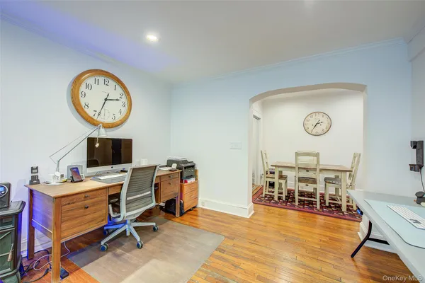 a view of a work space with furniture and wooden floor