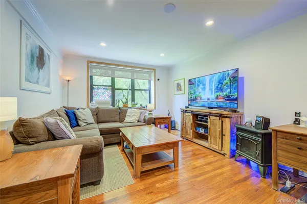 a living room with furniture a flat screen tv and a fireplace