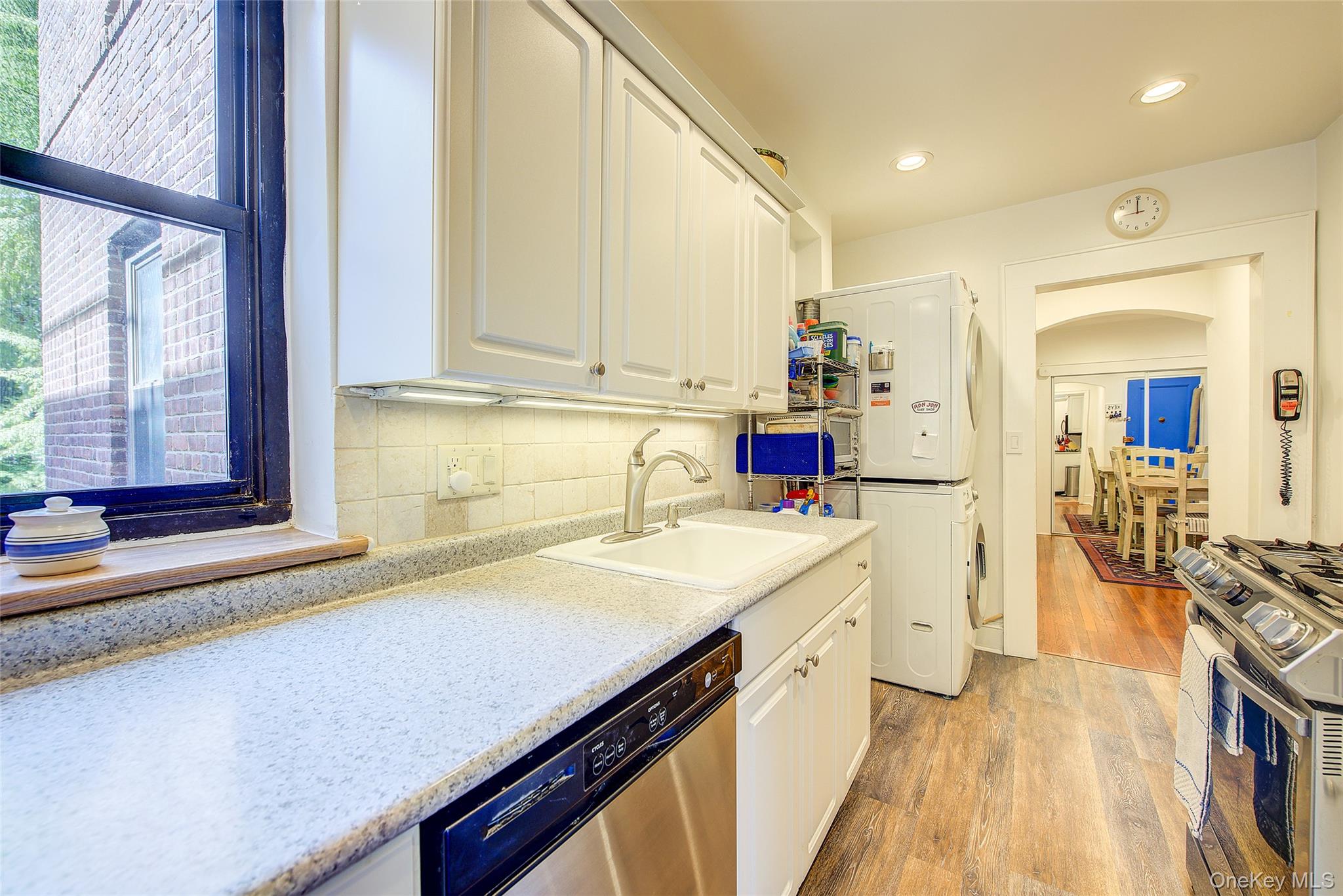 2 Town House Place, Unit 2H Great Neck, NY 11021 - Photo 26 of 43 a kitchen with a sink stove and cabinets