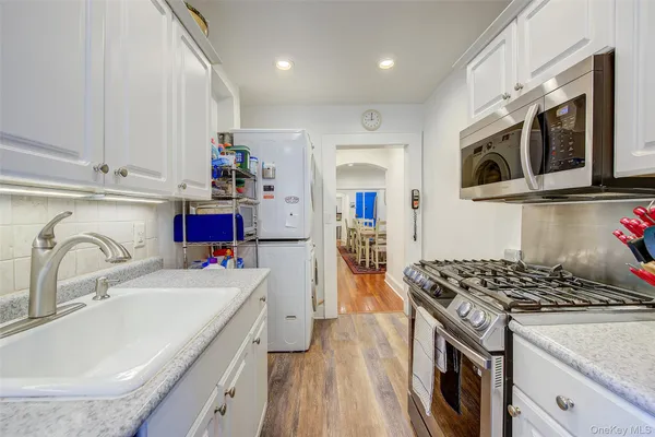 a kitchen with stainless steel appliances granite countertop a sink stove and refrigerator