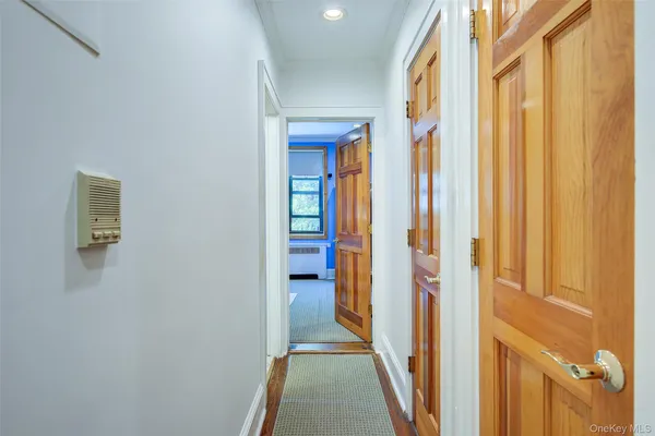 a view of a hallway with wooden floor and staircase
