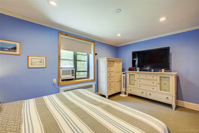 a bedroom with furniture and flat screen tv