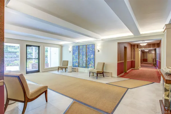 a bedroom with furniture and large windows