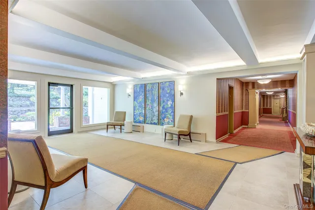 a bedroom with furniture and large windows