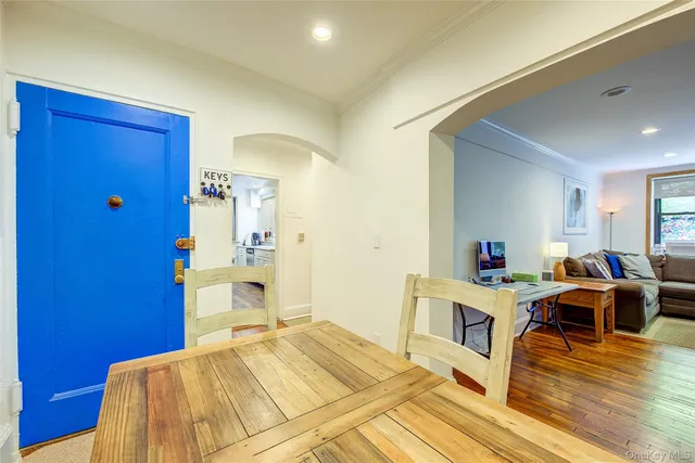 a bedroom with a bed and a view of kitchen