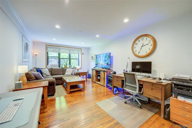 a living room with lots of furniture wooden floor and a clock